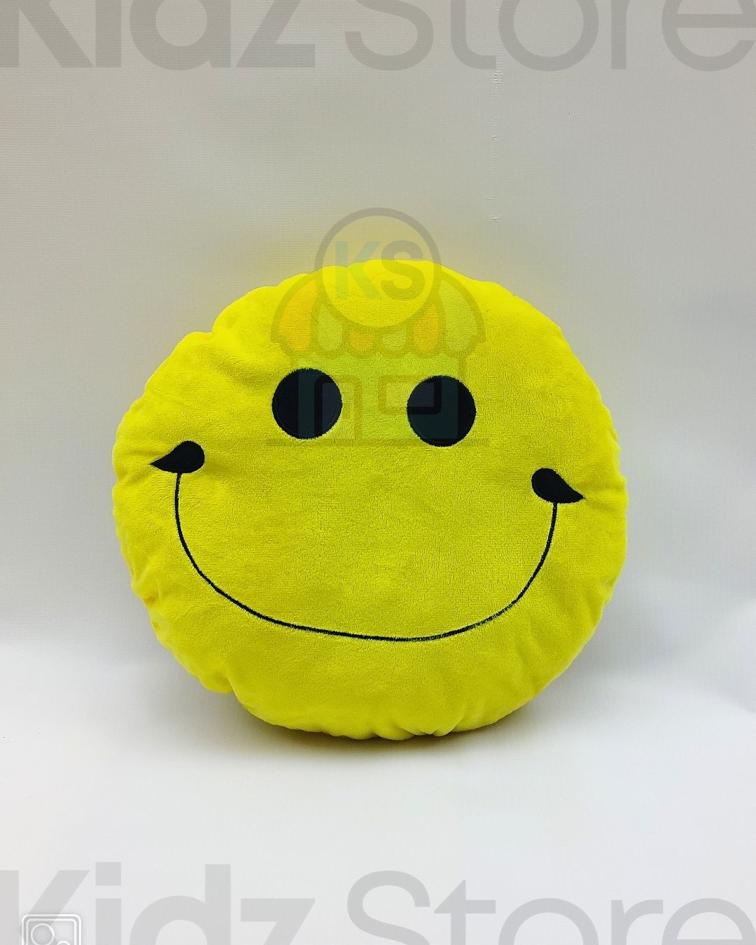 Yellow smiley face pillow on a white background with 'Kidz Store' branding.