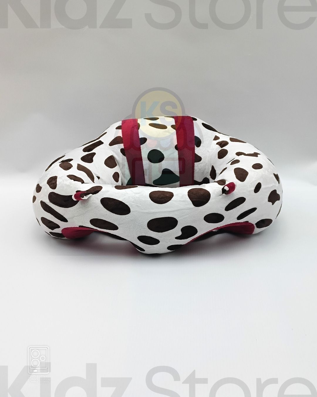 Donut-shaped cushion with polka dot pattern on a white background