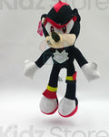 Plush toy of a character with black, red, and white colors on a light gray background.
