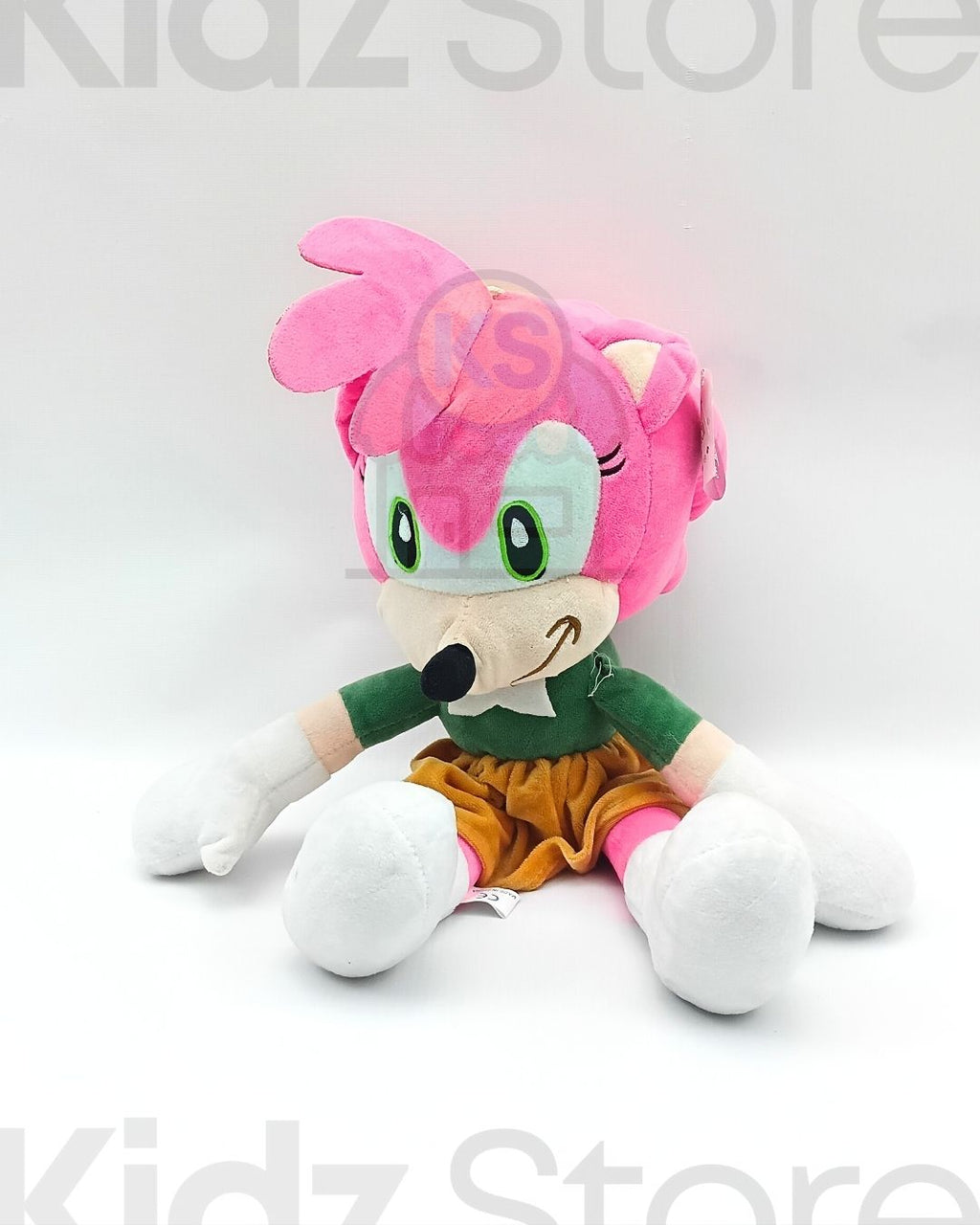 Plush toy with pink hair and green outfit on a white background