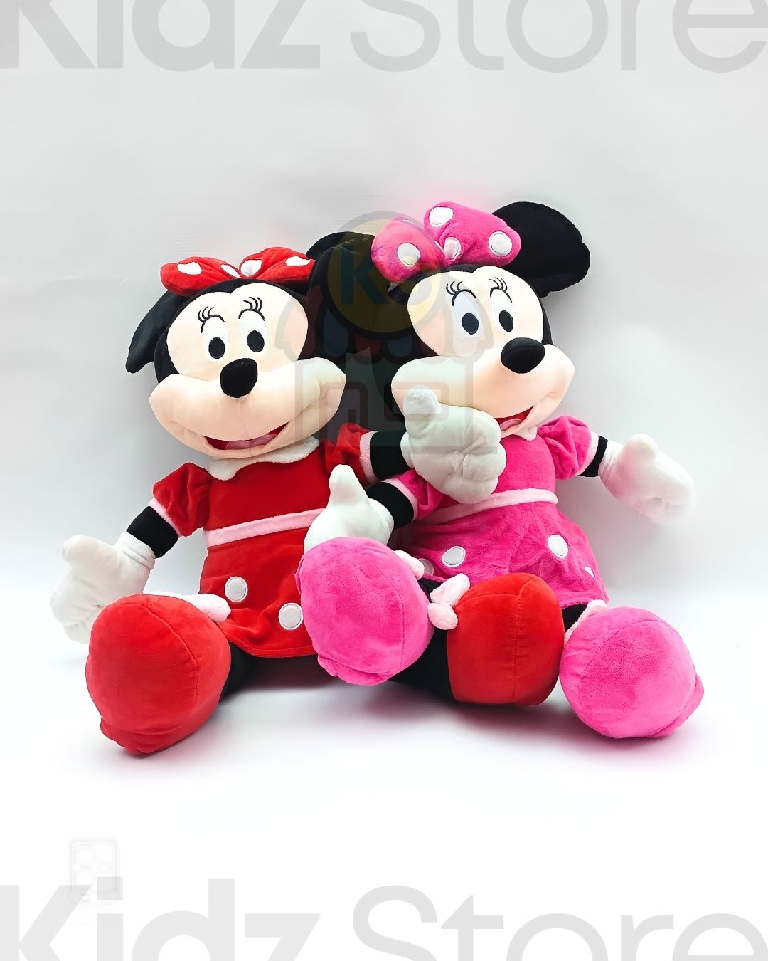 Two plush toys, one red and one pink, sitting side by side on a white background with 'Kidz Store' branding.