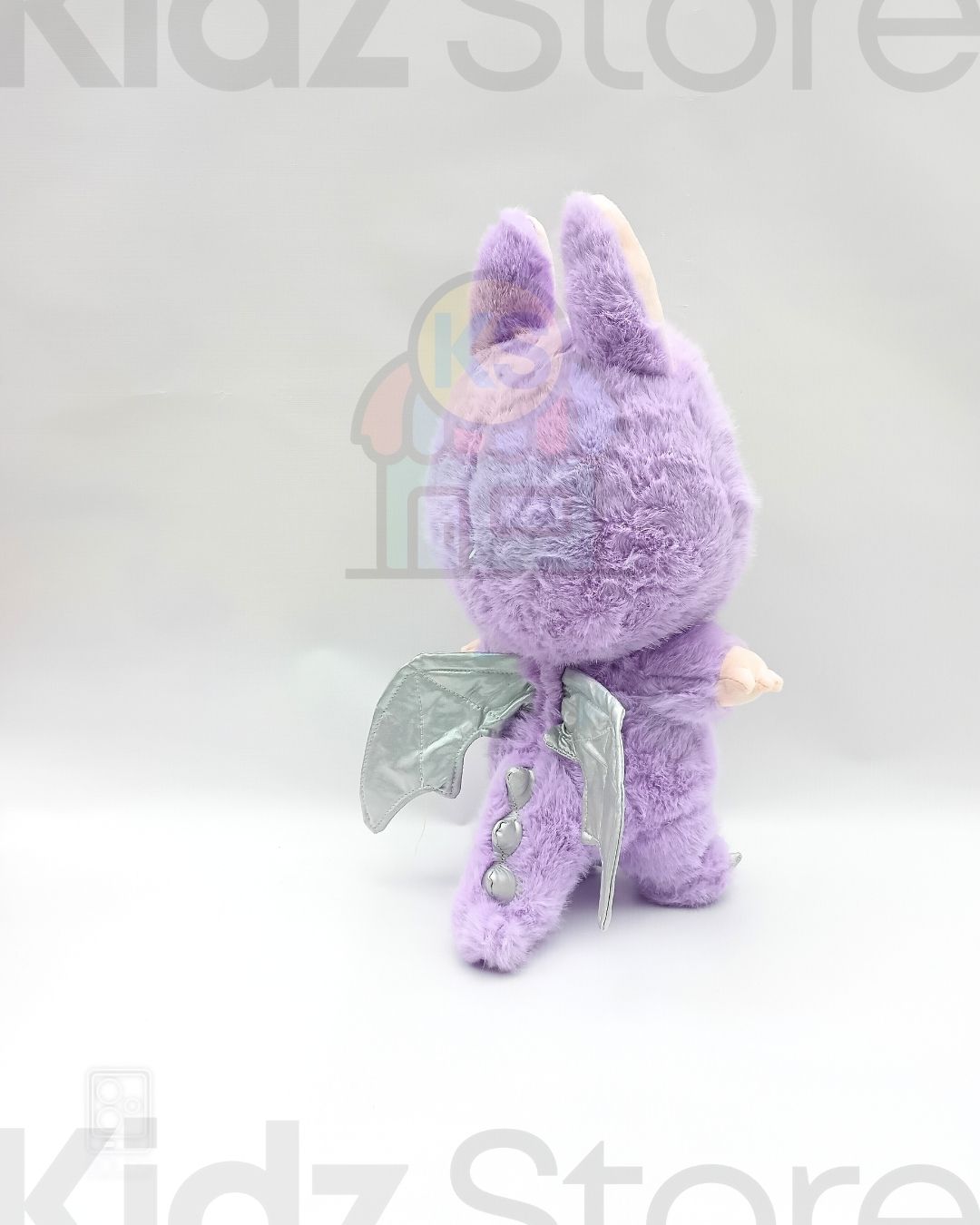Purple plush toy with wings on a white background