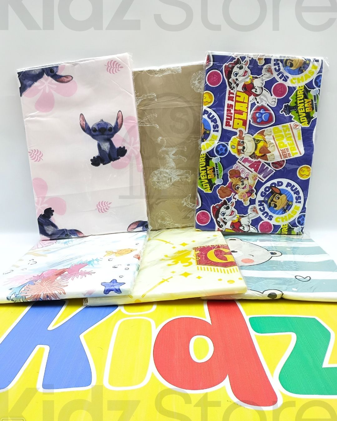 Collection of colorful children's books with cartoon characters on a 'Kidz Store' background