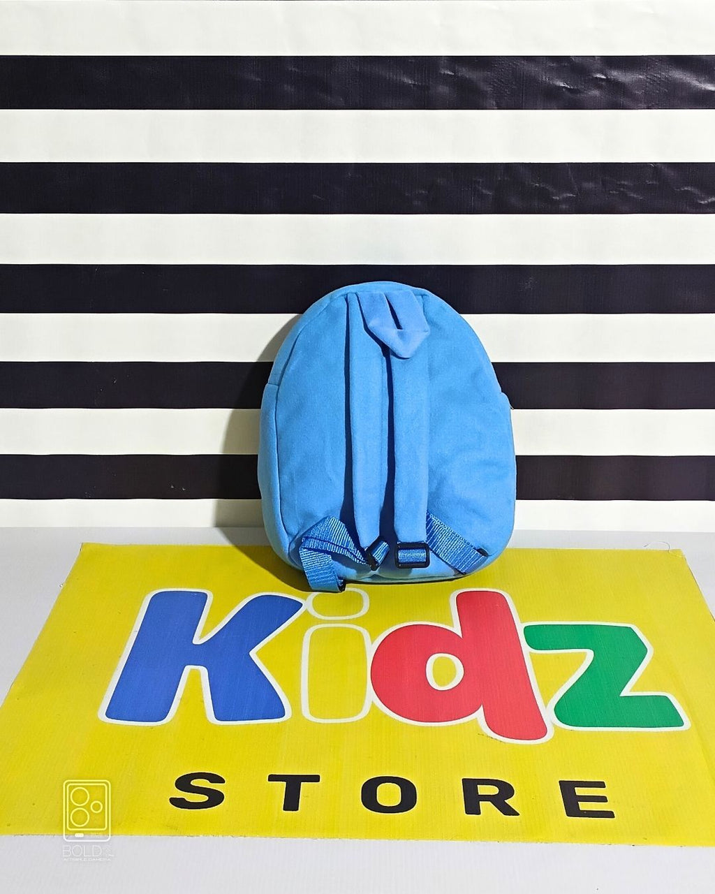 Blue cap on a striped background with 'Kidz Store' branding
